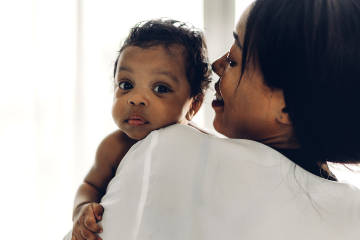 A woman holding a baby.